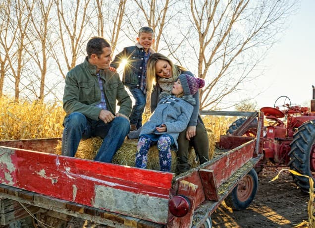 best-fall-activities: a family on a tractor.