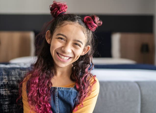 Best Temporary Hair Color for Kids 2024 universal image: a photo of a little girl with pink and brown hair