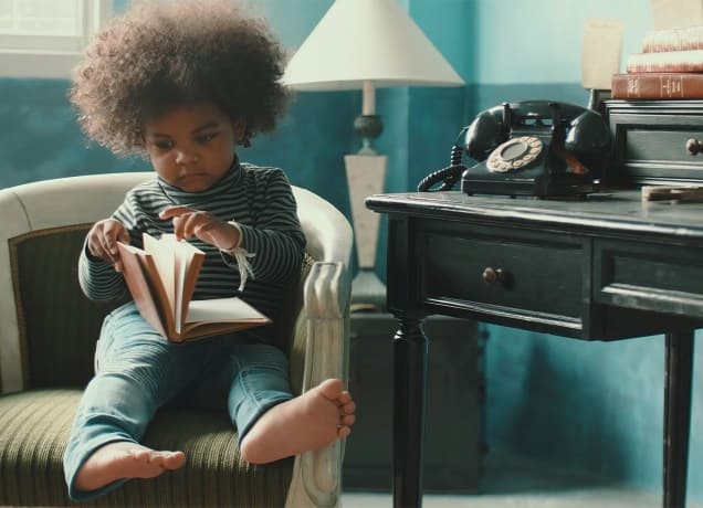 old-fashioned-baby-names: a little boy reading a book.