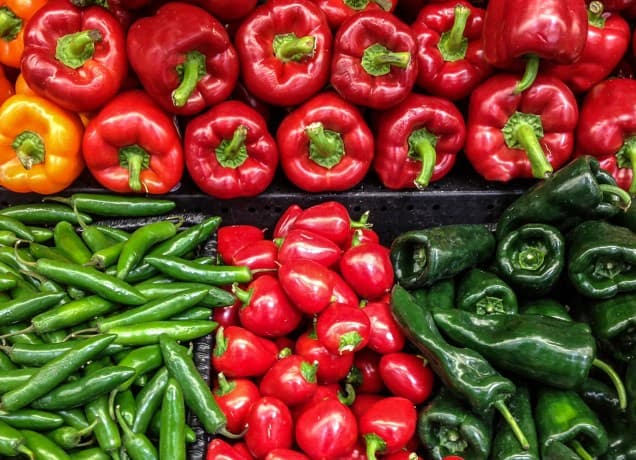 types of peppers: a bin of various sweet and hot peppers