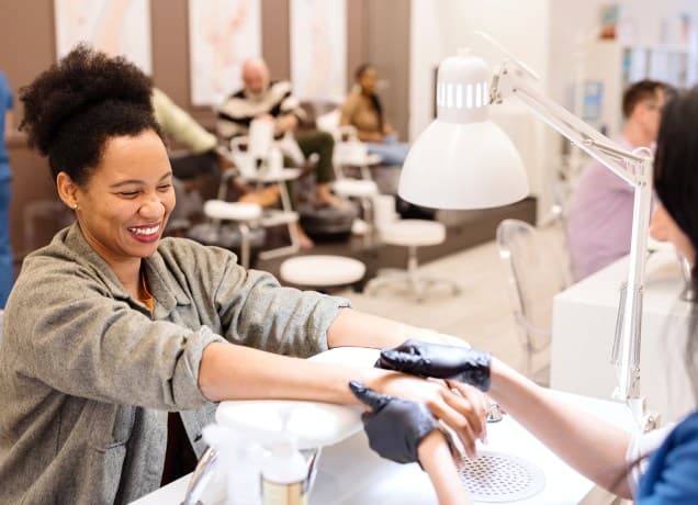 What Not to Say to a Manicurist universal image: a woman getting a manicure at a nail salon