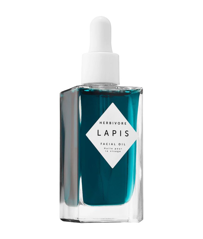 10 Products for Sensitive Skin - A clear rectangular glass bottle with a dropper top filled with teal liquid on a white background.