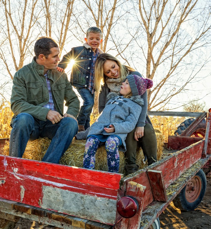 best-fall-activities: a family on a tractor.