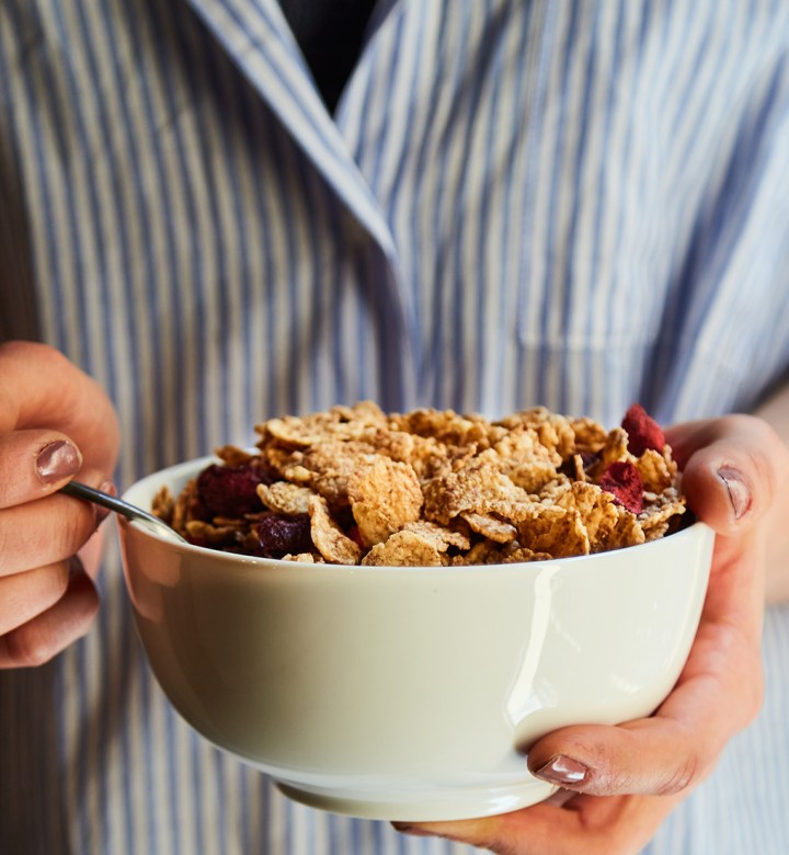 best high protein cereal: person eating cereal from a bowl