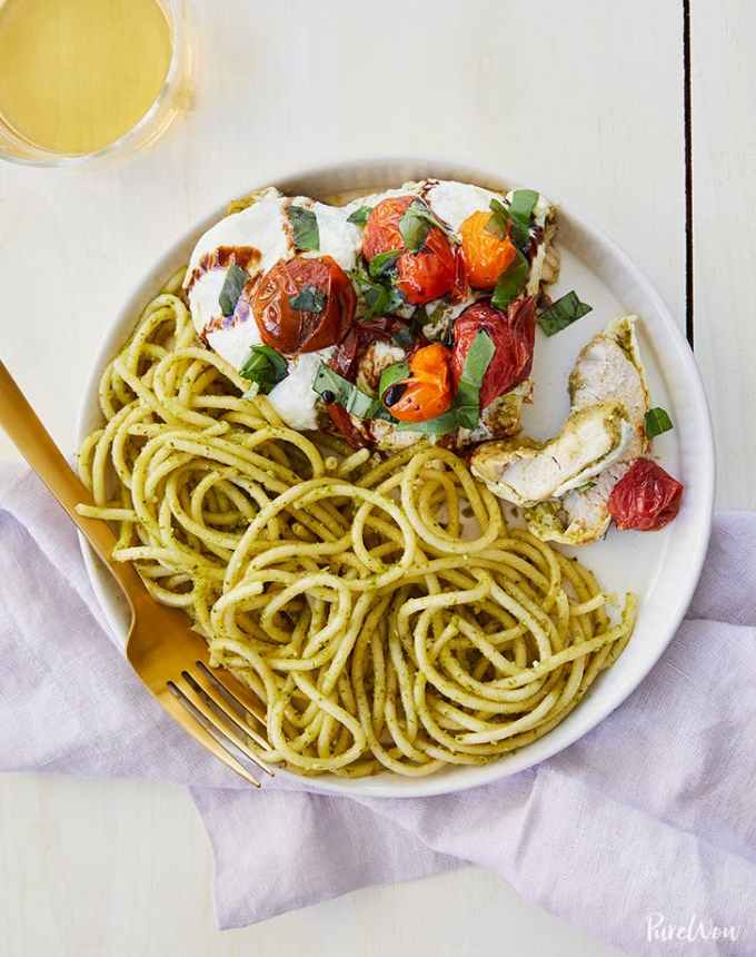 best big-batch recipes: baked caprese chicken on a plate with pesto noodles