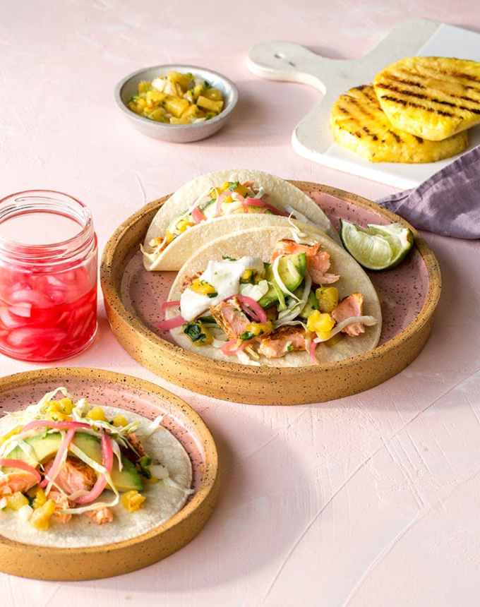 best big-batch recipes: roasted salmon tacos with pickled onions and pineapple salsa on plates