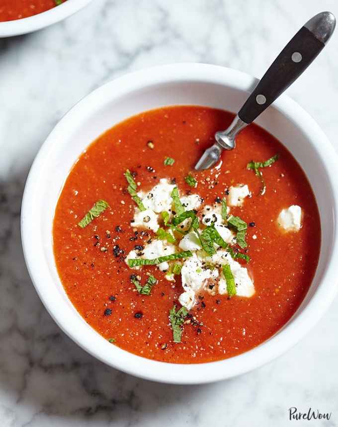 best big-batch recipes: bowl of roasted tomato soup finished with herbs and goat cheese