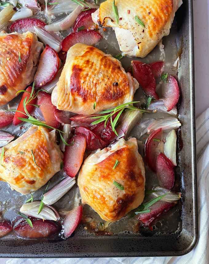 best big-batch recipes: close-up of buttermilk chicken thighs roasted with plums and red onions