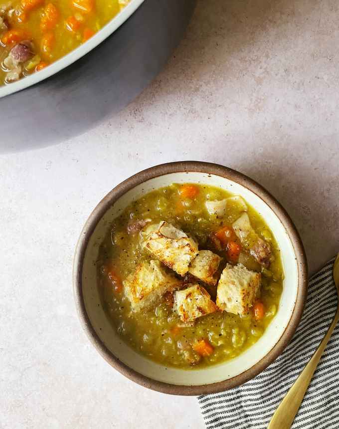 best big-batch recipes: bowl of split pea soup in front of a pot of split pea soup