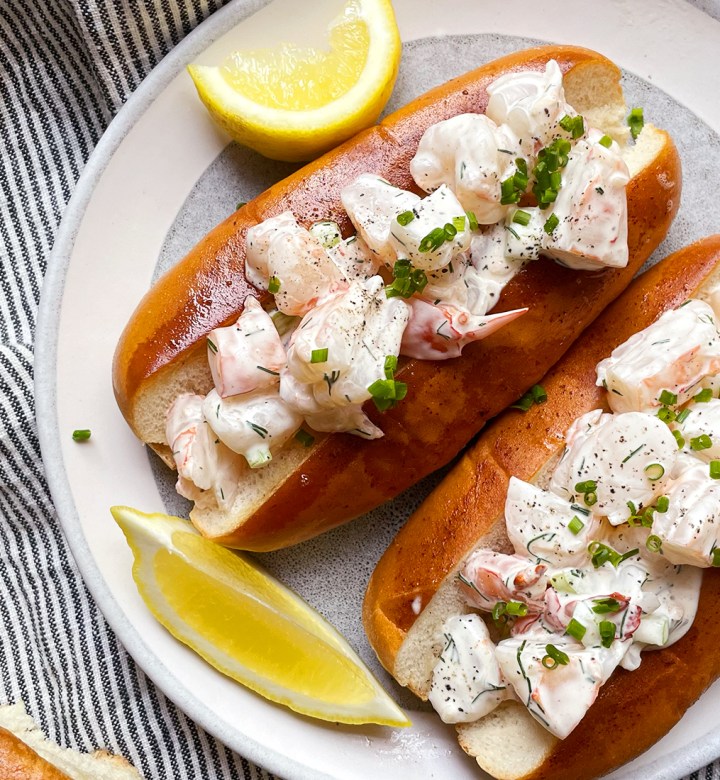 cold dinner recipes: a plate with two shrimp rolls and lemon wedges