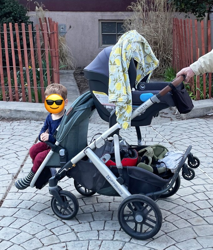 A family with a Disney-approved UPPAbaby Vista V2 stroller.