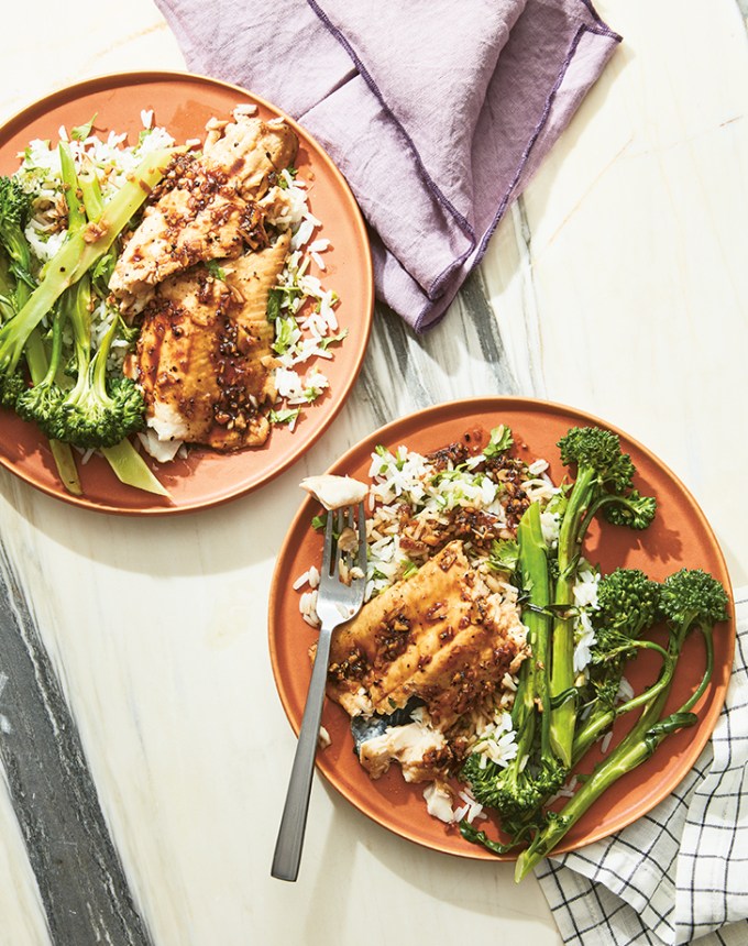 easy dinner recipes: two plates with rice, veggies and caramelized black pepper trout