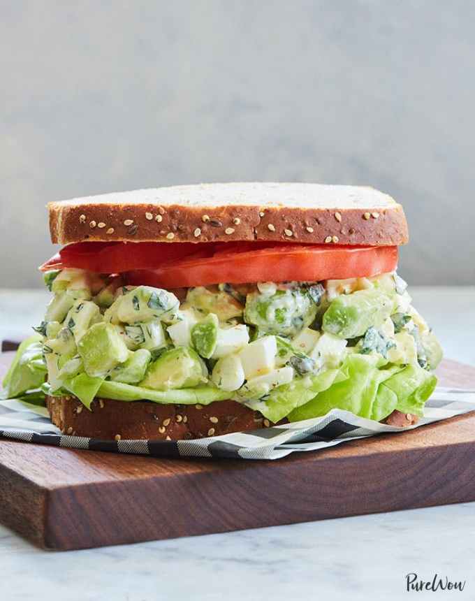 easy lunch ideas: avocado egg salad sandwich on cutting board