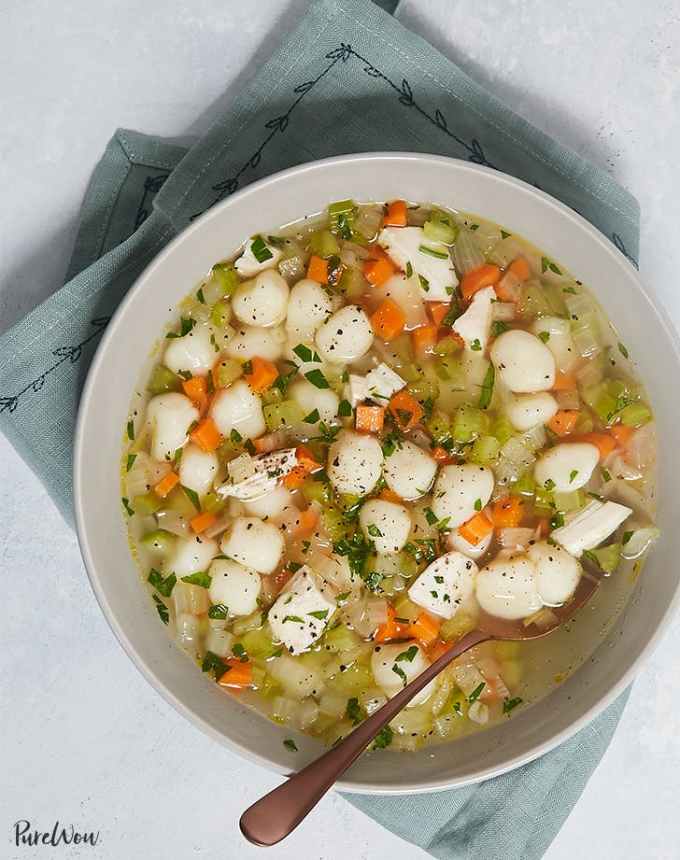 easy lunch ideas: bowl of chicken gnocchi soup on a linen with a spoon