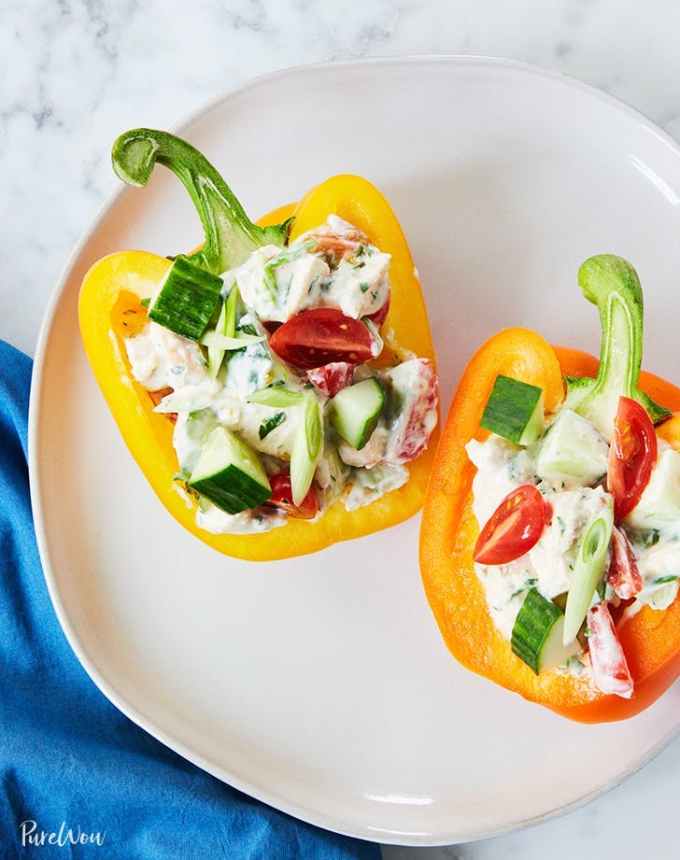 easy lunch ideas: two bell pepper halves on a plate stuffed with greek yogurt chicken salad