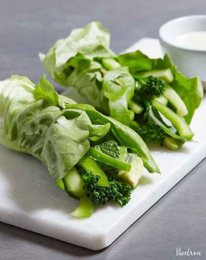 easy lunch ideas: two green goddess wraps on a tray with a cup of dressing for dipping