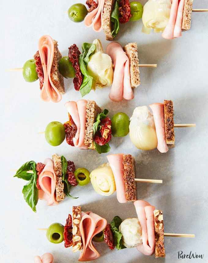 easy lunch ideas: lunch kebabs on a marble counter with mortadella, artichoke and sun-dried tomatoes