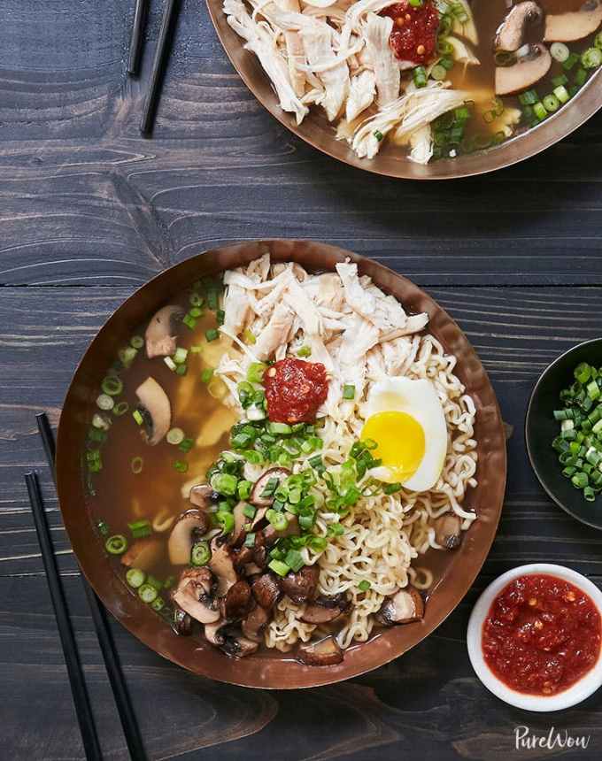 easy lunch ideas: two bowls of rotisserie chicken ramen topped with soft-boiled egg and chili sauce