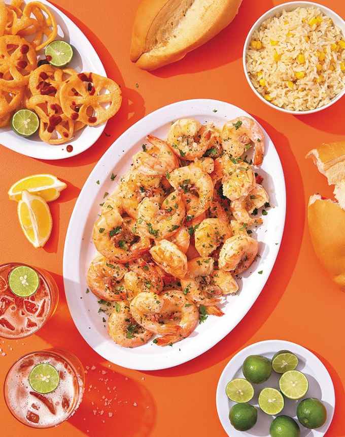 easy lunch ideas: platter of garlic butter shrimp with rice, rolls and limes