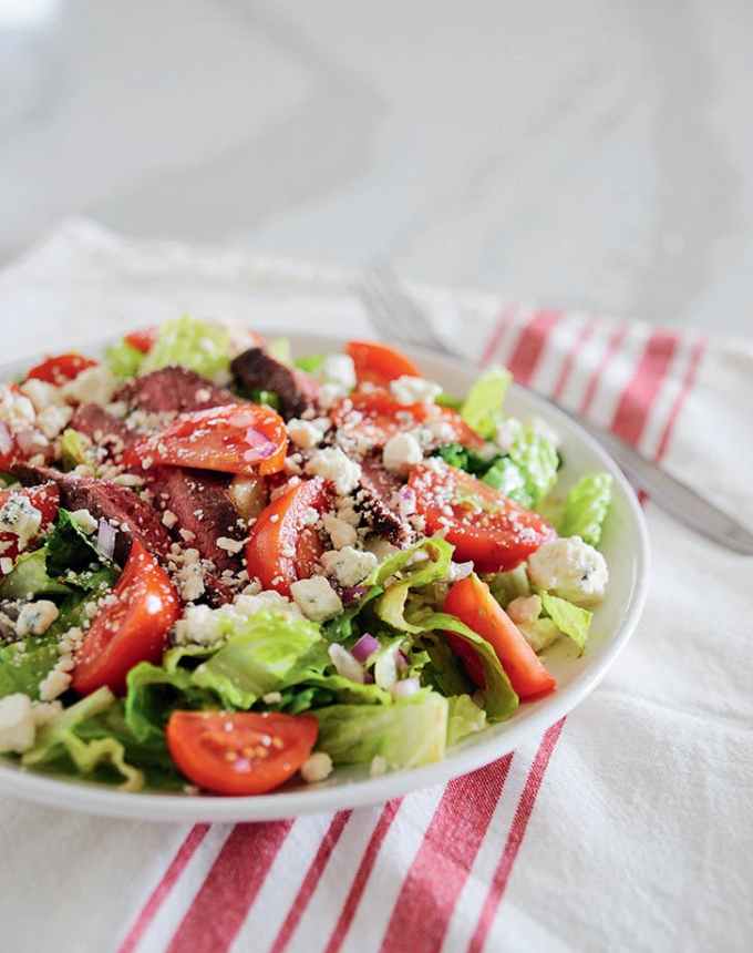 easy lunch ideas: plate of steak blue cheese salad on a pink and white linen