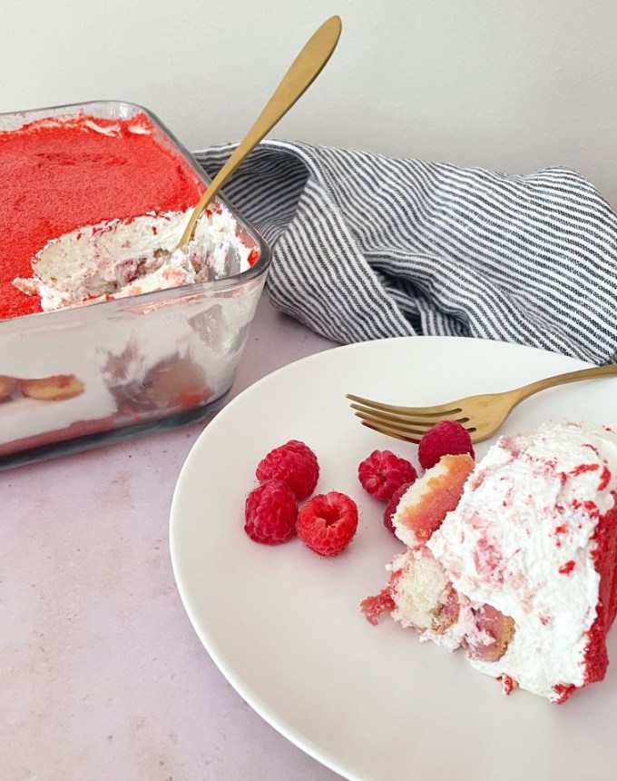 fun things to bake: slice of raspberry tiramisu on a plate with the dish of tiramisu in the background