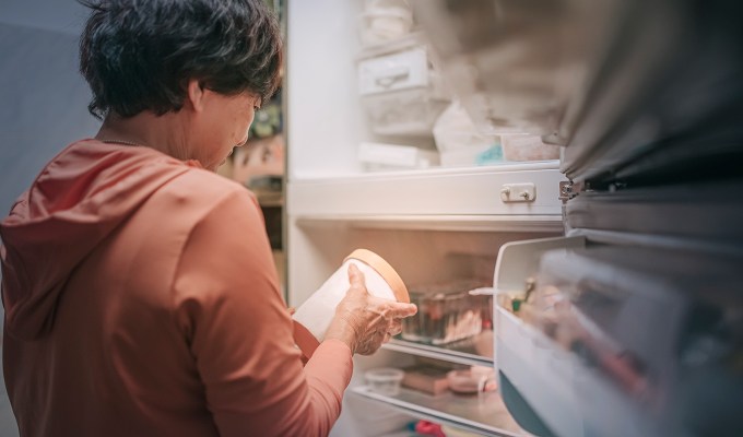 Ina Garten cooking tips: a person taking a pint of ice cream out of the freezer