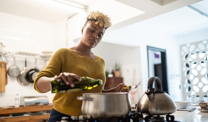 Ina Garten cooking tips: a woman cooking with good olive oil