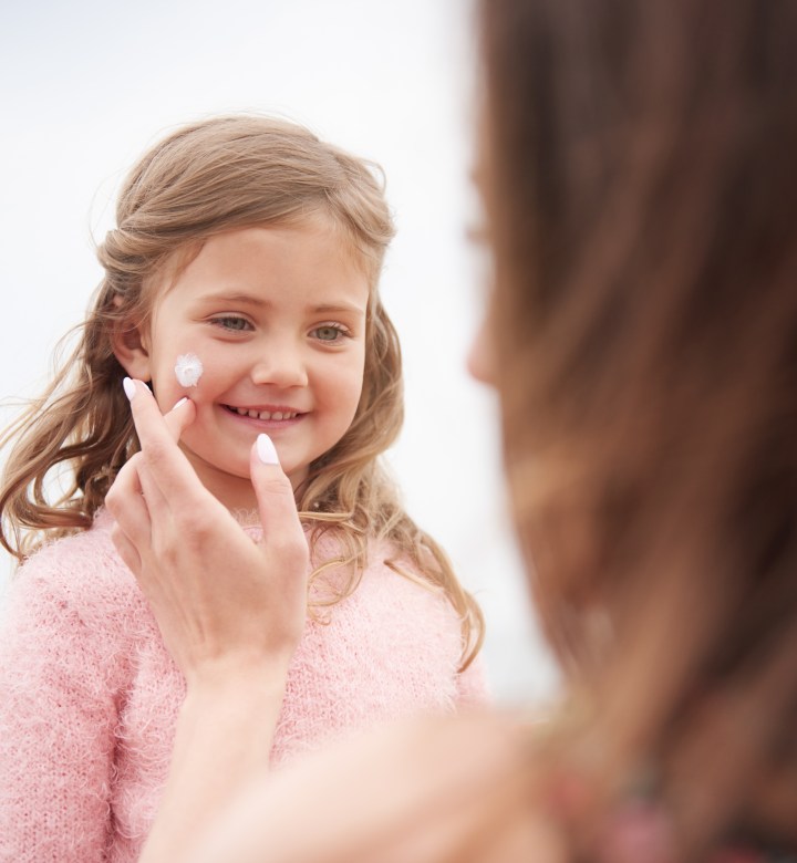 mom applying sunscreen to kid