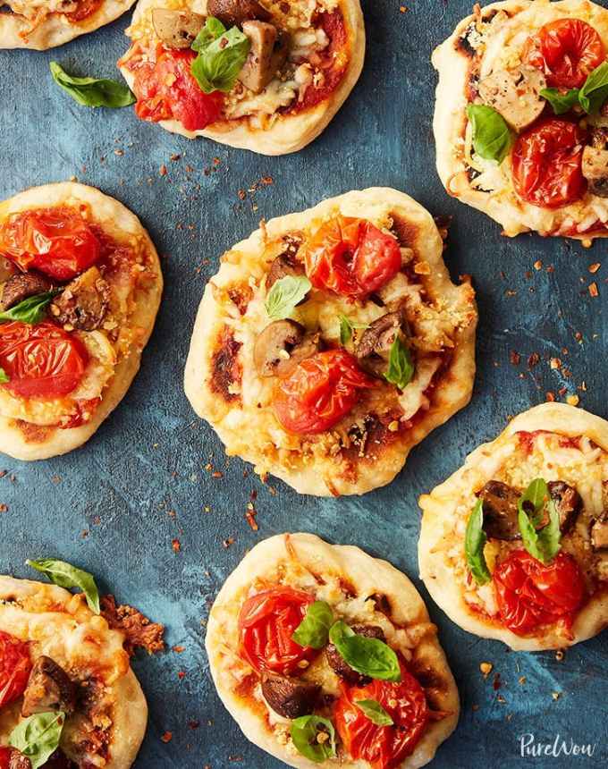 best big-batch recipes: mini skillet pizzas topped with vegetables on a counter