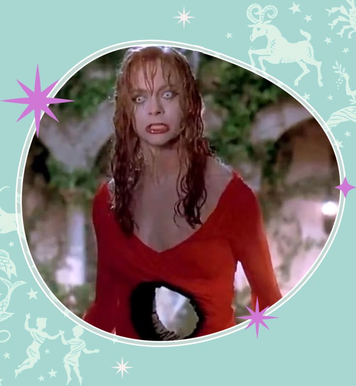 weeklyhoroscopes-august-18-24: A photograph of Goldie Hawn in Death Becomes Her. She has red hair and a red dress on. There is a giant hole through her stomach and she looks furious. There is a sea foam green celestial border with white and pink writing around it.