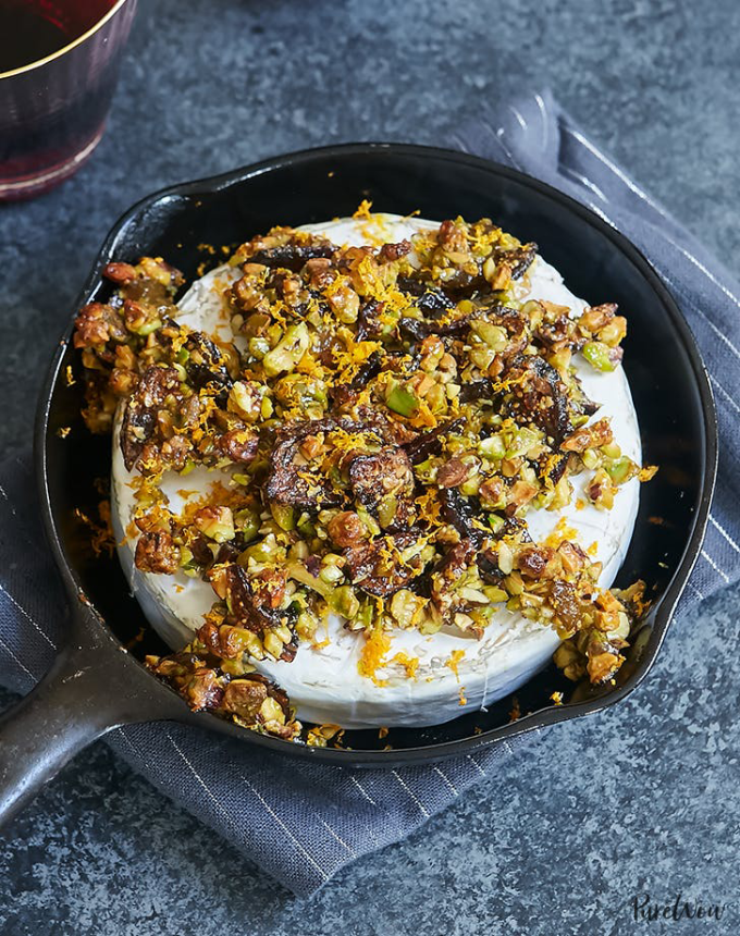 best big-batch recipes: baked brie topped with figs, pistachios and orange zest, in a small cast iron skillet