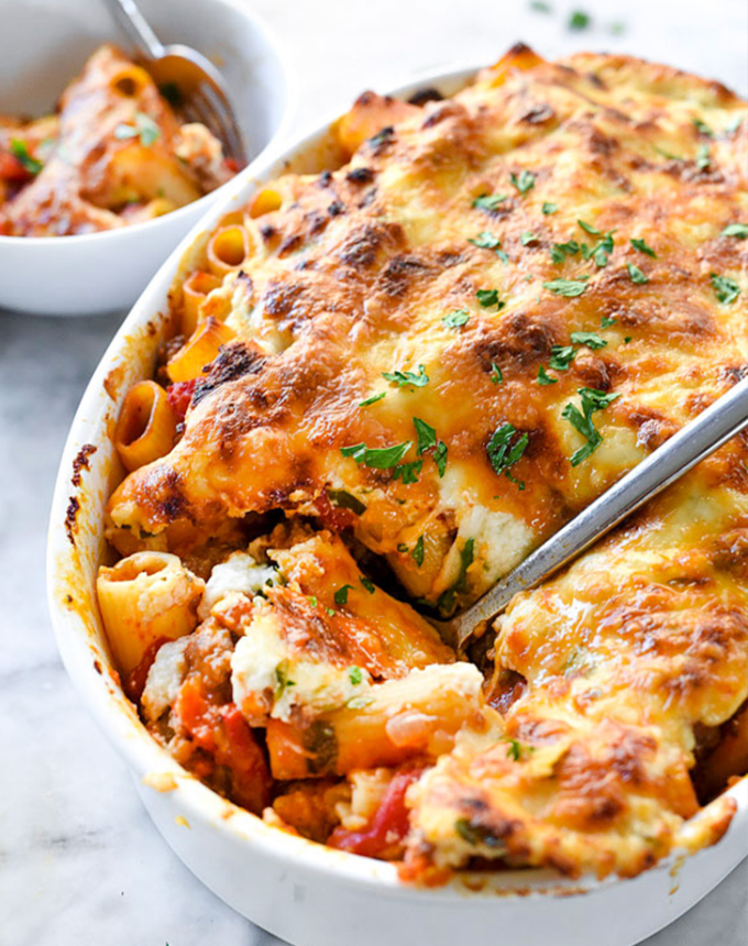 best big-batch recipes: baked sausage and cheese rigatoni in a baking dish with a spoon