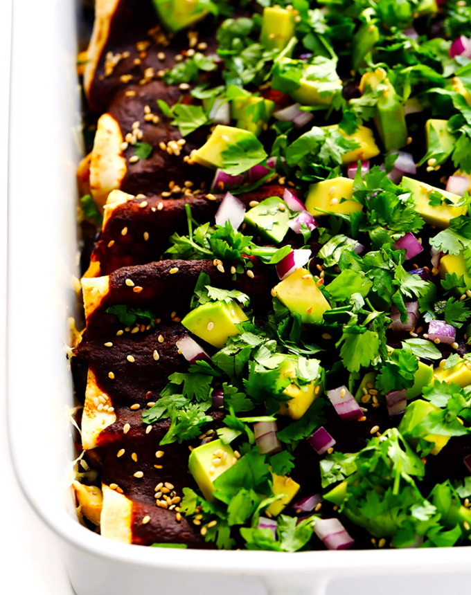 best big-batch recipes: close-up of mole enchiladas topped with avocado