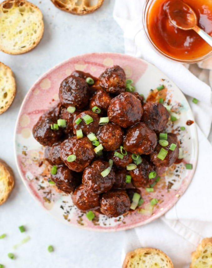 best big-batch recipes: stack of slow cooker chipotle bbq meatballs with garlic toast on a plate